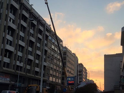 lifting air conditioning units on building in center of Thessaloniki